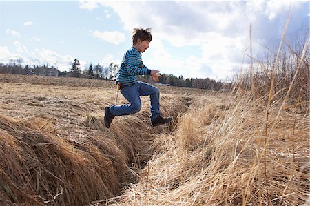simsearch:700-00519358,k - Boy jumping across field ditch Stock Photo - Premium Royalty-Free, Code: 649-09166467