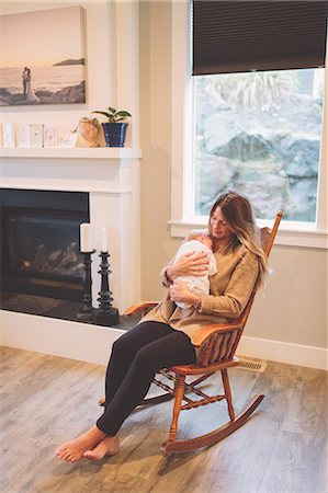 simsearch:859-06808650,k - Mother sitting in rocking chair holding newborn baby boy Stock Photo - Premium Royalty-Free, Code: 649-09166578