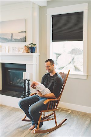 simsearch:859-06808650,k - Father sitting in rocking chair holding newborn baby boy Stock Photo - Premium Royalty-Free, Code: 649-09166570