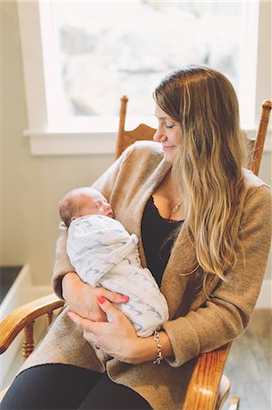 simsearch:859-06808650,k - Mother sitting in rocking chair holding newborn baby boy Stock Photo - Premium Royalty-Free, Code: 649-09166572