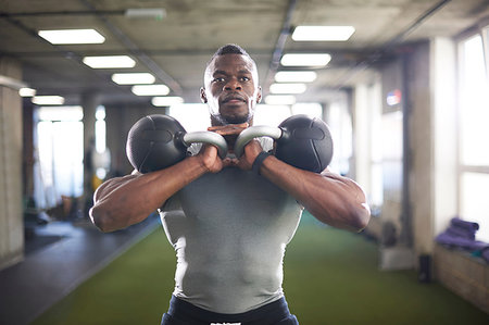 Man lifting kettlebells in gym Stock Photo - Premium Royalty-Free, Code: 649-09176861