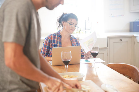 simsearch:649-07761247,k - Man preparing vegetables at kitchen table, girlfriend reading paperwork Stock Photo - Premium Royalty-Free, Code: 649-09182392