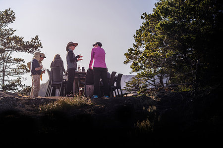 simsearch:614-08030822,k - Friends talking at dinner on cliff top, Johnstone Strait, Telegraph Cove, Canada Stock Photo - Premium Royalty-Free, Code: 649-09196286