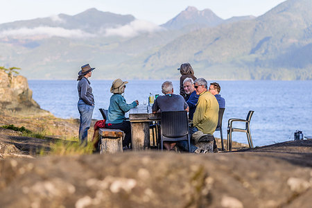 simsearch:614-08030822,k - Friends talking at dinner on lakeside, Johnstone Strait, Telegraph Cove, Canada Stock Photo - Premium Royalty-Free, Code: 649-09196288