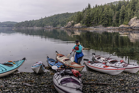 simsearch:693-06667811,k - Woman with sea kayaks on lakeside, Johnstone Strait, Telegraph Cove, Canada Stock Photo - Premium Royalty-Free, Code: 649-09196312