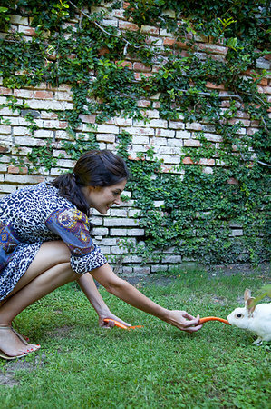 Woman feeding carrots to a rabbit Stock Photo - Premium Royalty-Free, Code: 649-09205689