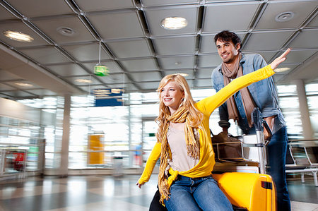 simsearch:649-05556309,k - Couple playing with luggage in airport Stock Photo - Premium Royalty-Free, Code: 649-09206246