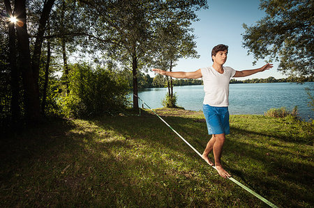 Man walking on tight rope outdoors Stock Photo - Premium Royalty-Free, Code: 649-09206274