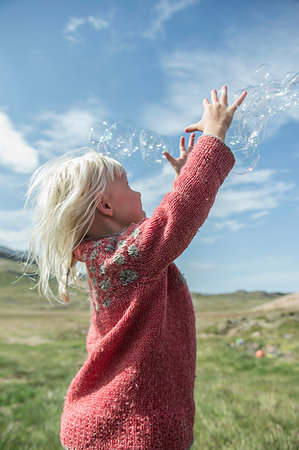 simsearch:649-07647801,k - Young girl reaching to catch bubbles Stock Photo - Premium Royalty-Free, Code: 649-09207160