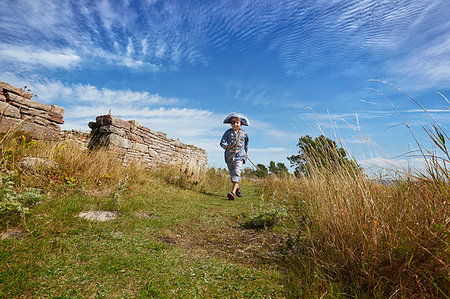 simsearch:649-06845253,k - Boy wearing pirate costume running along grass, Eggergrund, Sweden Stock Photo - Premium Royalty-Free, Code: 649-09207387