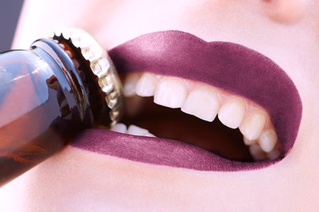 simsearch:649-07436630,k - Close up young woman removing bottle top with teeth Stock Photo - Premium Royalty-Free, Code: 649-09207463