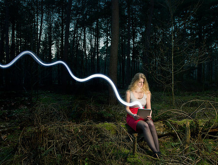 simsearch:649-07560130,k - Illuminated wavy line and young woman with digital tablet in forest Stock Photo - Premium Royalty-Free, Code: 649-09207625