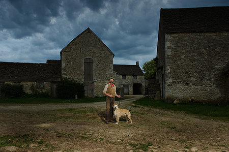 simsearch:649-07560533,k - Portrait of mature traditional farmer and his lurcher dog in farmyard Photographie de stock - Premium Libres de Droits, Code: 649-09207736