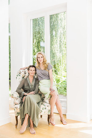 Portrait of senior woman and daughter sitting on armchair in living room Stock Photo - Premium Royalty-Free, Code: 649-09208319