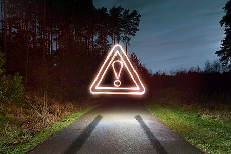 skid marks - Tyre skid marks and glowing road warning sign above forest road at night Stock Photo - Premium Royalty-Free, Code: 649-09208376
