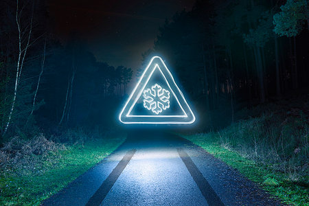 skid marks - Tyre skid marks and glowing snow warning road sign above forest road at night Stock Photo - Premium Royalty-Free, Code: 649-09208378