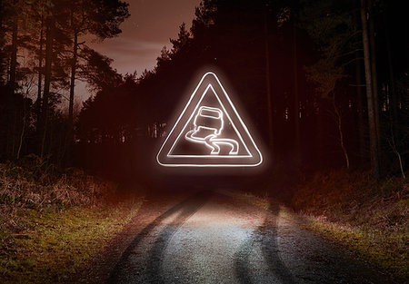 skid marks - Tyre skid marks and glowing slippery warning sign above forest road at night Stock Photo - Premium Royalty-Free, Code: 649-09208379