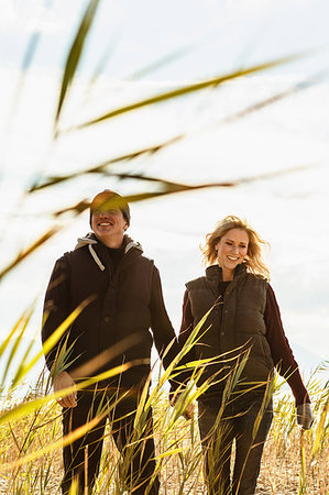 simsearch:649-08239088,k - Mature couple walking through field, hand in hand, smiling Stock Photo - Premium Royalty-Free, Code: 649-09209275