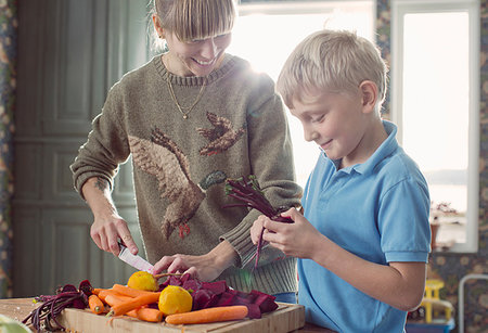 eco friendly home - Mother and son preparing organic vegetables in kitchen Stock Photo - Premium Royalty-Free, Code: 649-09209359