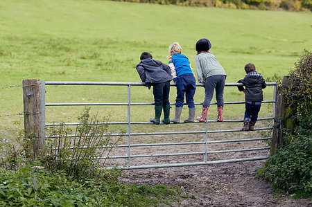 simsearch:649-07520254,k - Rear view of four young children standing on gate looking out to field Stock Photo - Premium Royalty-Free, Code: 649-09209414
