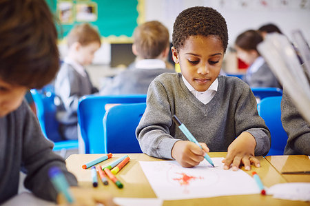 simsearch:649-01696512,k - Boys drawing at desks in elementary school classroom Stock Photo - Premium Royalty-Free, Code: 649-09209412