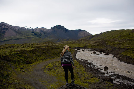 simsearch:614-06625125,k - Rear view of mid adult woman by river looking at mountain range, Iceland Stock Photo - Premium Royalty-Free, Code: 649-09209451