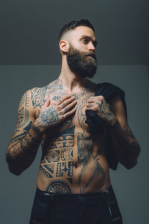 simsearch:614-08392638,k - Portrait of  young man with beard, bare chest covered in tattoos Stock Photo - Premium Royalty-Free, Code: 649-09212512