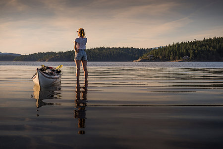 Young female kayaker standing looking out over lake, Quadra Island, Campbell River, Canada Stock Photo - Premium Royalty-Free, Code: 649-09213579