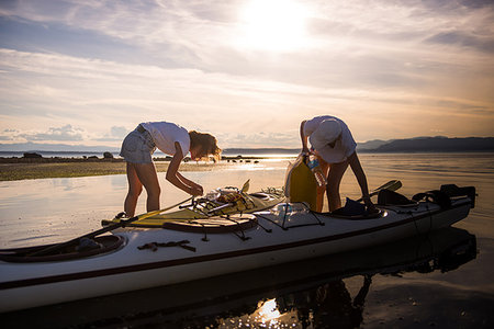 Two female kayakers preparing kayak, Quadra Island, Campbell River, Canada Stock Photo - Premium Royalty-Free, Code: 649-09213584