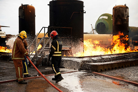 simsearch:649-07239830,k - Firemen training, spraying firefighting foam onto oil storage tank fire at training facility Stock Photo - Premium Royalty-Free, Code: 649-09230168