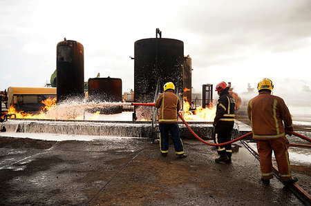 simsearch:649-07239830,k - Firemen training, spraying firefighting foam onto oil storage tank fire at training facility Stock Photo - Premium Royalty-Free, Code: 649-09230169