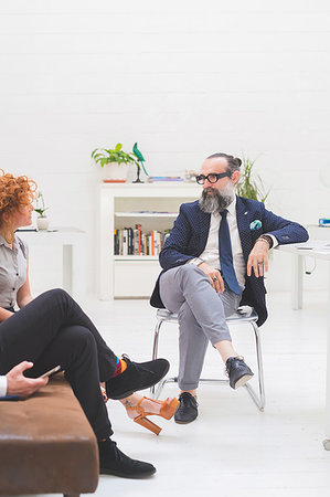 simsearch:649-06845199,k - Businessmen and woman having discussion at meeting on office sofa, cropped Stock Photo - Premium Royalty-Free, Code: 649-09230629
