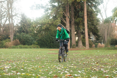 simsearch:693-05552857,k - Mature woman cycling in park Stock Photo - Premium Royalty-Free, Code: 649-09230864