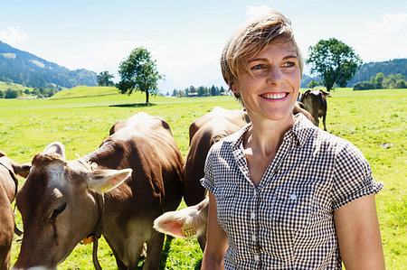 simsearch:649-07239413,k - Woman bonding with herd of cows on field, Sonthofen, Bayern, Germany Stock Photo - Premium Royalty-Free, Code: 649-09246335