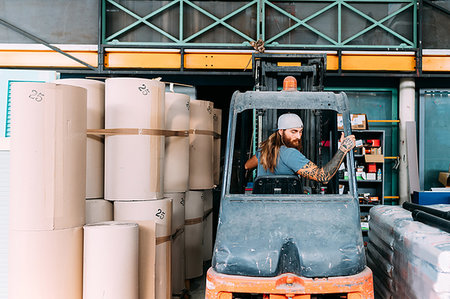 self-employed (male) - Man reversing fork lift out of warehouse Stock Photo - Premium Royalty-Free, Code: 649-09246456