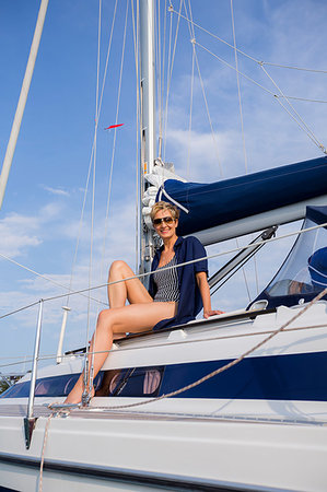 simsearch:649-08900720,k - Mature woman sitting on sailboat on Chiemsee lake, portrait, Bavaria, Germany Stock Photo - Premium Royalty-Free, Code: 649-09246495