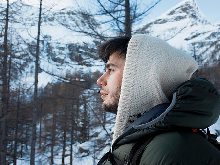 simsearch:649-08924209,k - Mid adult man in hooded sweater in snow covered mountain forest  landscape, portrait, Alpe Ciamporino, Piemonte, Italy Stock Photo - Premium Royalty-Free, Code: 649-09246589