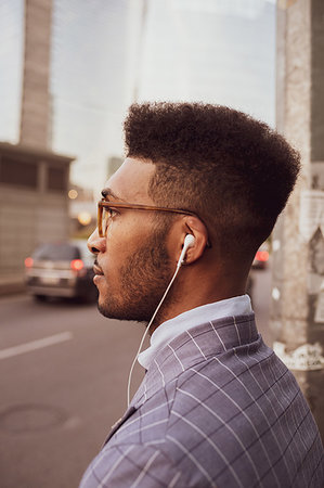 simsearch:614-06718128,k - Businessman with earphones on pavement Stock Photo - Premium Royalty-Free, Code: 649-09257387