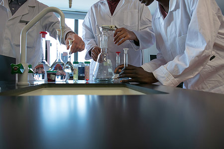 simsearch:649-08085222,k - Male and female scientists preparing experiment with sample bottles in laboratory, mid section Stock Photo - Premium Royalty-Free, Code: 649-09258389