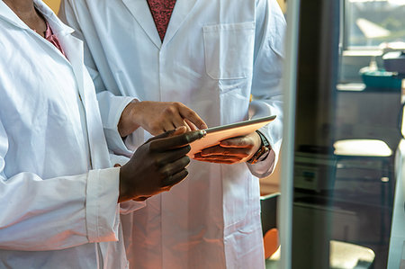 simsearch:649-07585094,k - Young female and male scientists using digital tablet in laboratory, mid section Stock Photo - Premium Royalty-Free, Code: 649-09258380