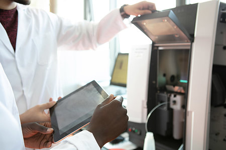 simsearch:649-07585094,k - Young female and male scientists using digital tablet in laboratory, mid section Stock Photo - Premium Royalty-Free, Code: 649-09258383