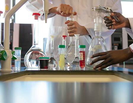 simsearch:649-08085222,k - Young male and female scientists preparing experiment with sample bottles in laboratory, cropped Stock Photo - Premium Royalty-Free, Code: 649-09258391