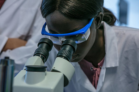 simsearch:649-07063859,k - Young female scientist looking through microscope in laboratory, close up Stock Photo - Premium Royalty-Free, Code: 649-09258392