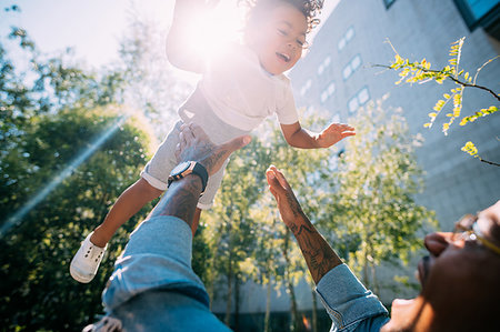simsearch:632-03848361,k - Father throwing son up in air in park Stock Photo - Premium Royalty-Free, Code: 649-09250140