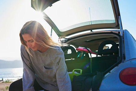 simsearch:649-07280823,k - Young woman standing behind open car boot Stock Photo - Premium Royalty-Free, Code: 649-09250151