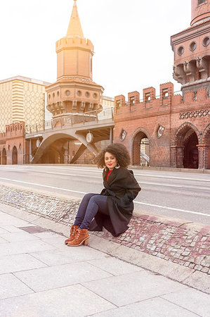 simsearch:649-08922723,k - Mid adult woman in stylish coat sitting on Oberbaum Bridge, portrait, Berlin, Germany Stock Photo - Premium Royalty-Free, Code: 649-09250336