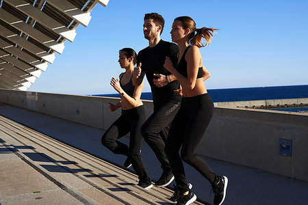 simsearch:649-07520907,k - Friends jogging up steps in sports stadium Stock Photo - Premium Royalty-Free, Code: 649-09250768