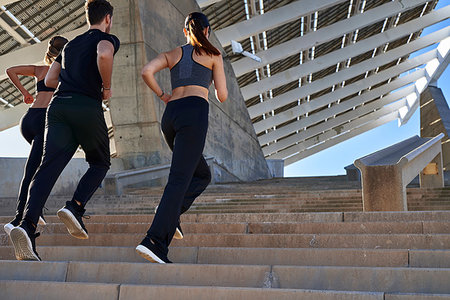 simsearch:649-07520907,k - Friends jogging up steps in sports stadium Stock Photo - Premium Royalty-Free, Code: 649-09250774