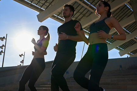 simsearch:649-07520907,k - Friends jogging down steps in sports stadium Stock Photo - Premium Royalty-Free, Code: 649-09250775