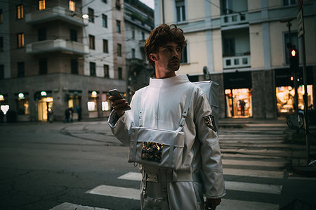 Astronaut using smartphone on pedestrian crossing Stock Photo - Premium Royalty-Free, Code: 649-09251045